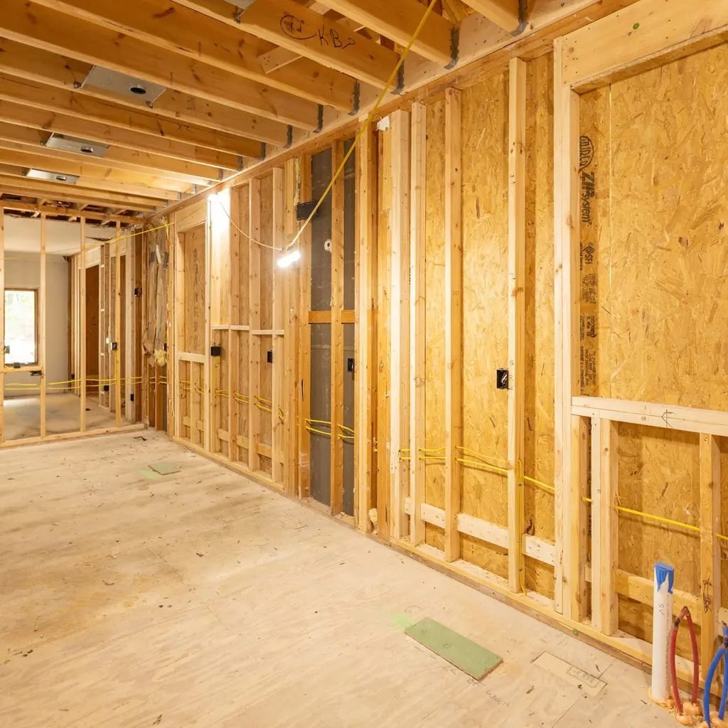 Interior wall framing and exposed studs inside a custom home under construction