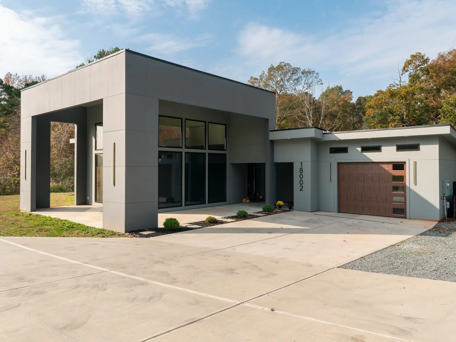 Modern custom home exterior with an attached garage and concrete driveway in Charlotte, NC